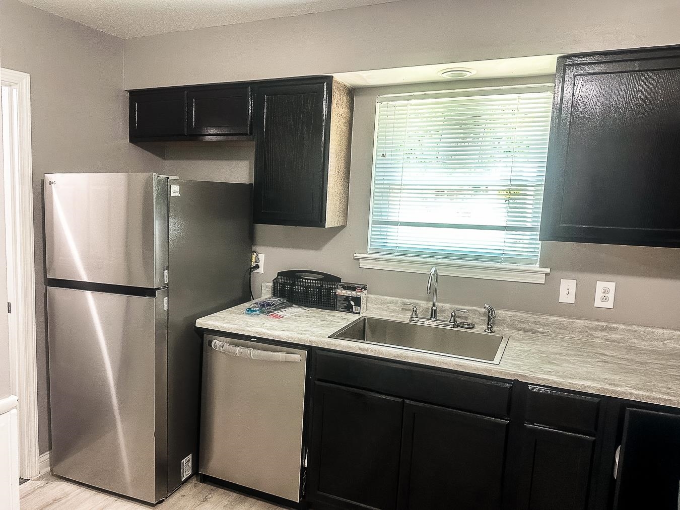 3909 Range Line Road Memphis, TN 38127 - Photo 12 of 31 a kitchen with a refrigerator sink and cabinets