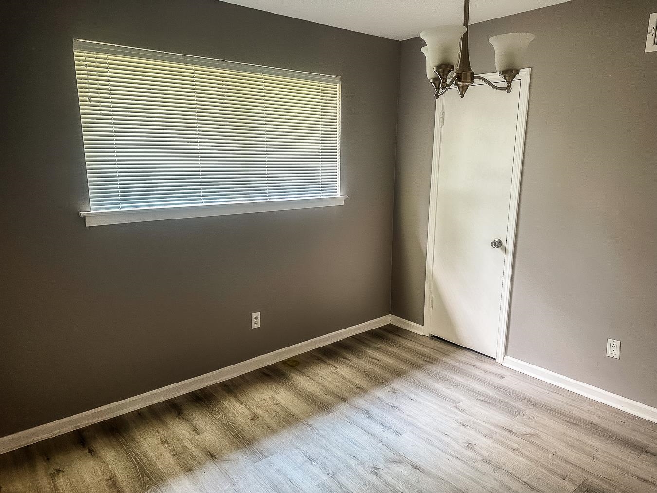 3909 Range Line Road Memphis, TN 38127 - Photo 14 of 31 an empty room with wooden floor and windows