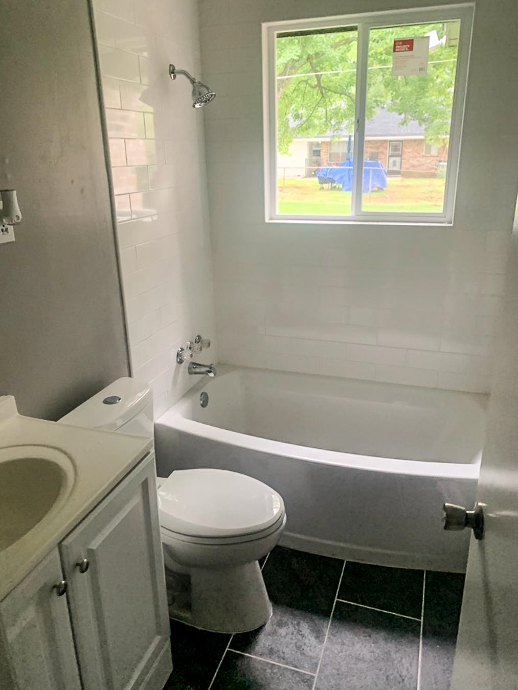 3909 Range Line Road Memphis, TN 38127 - Photo 28 of 31 a bathroom with a sink a toilet a mirror and a tub