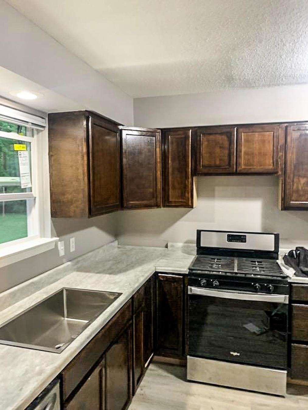 3909 Range Line Road Memphis, TN 38127 - Photo 8 of 31 a kitchen with granite countertop a stove and a sink
