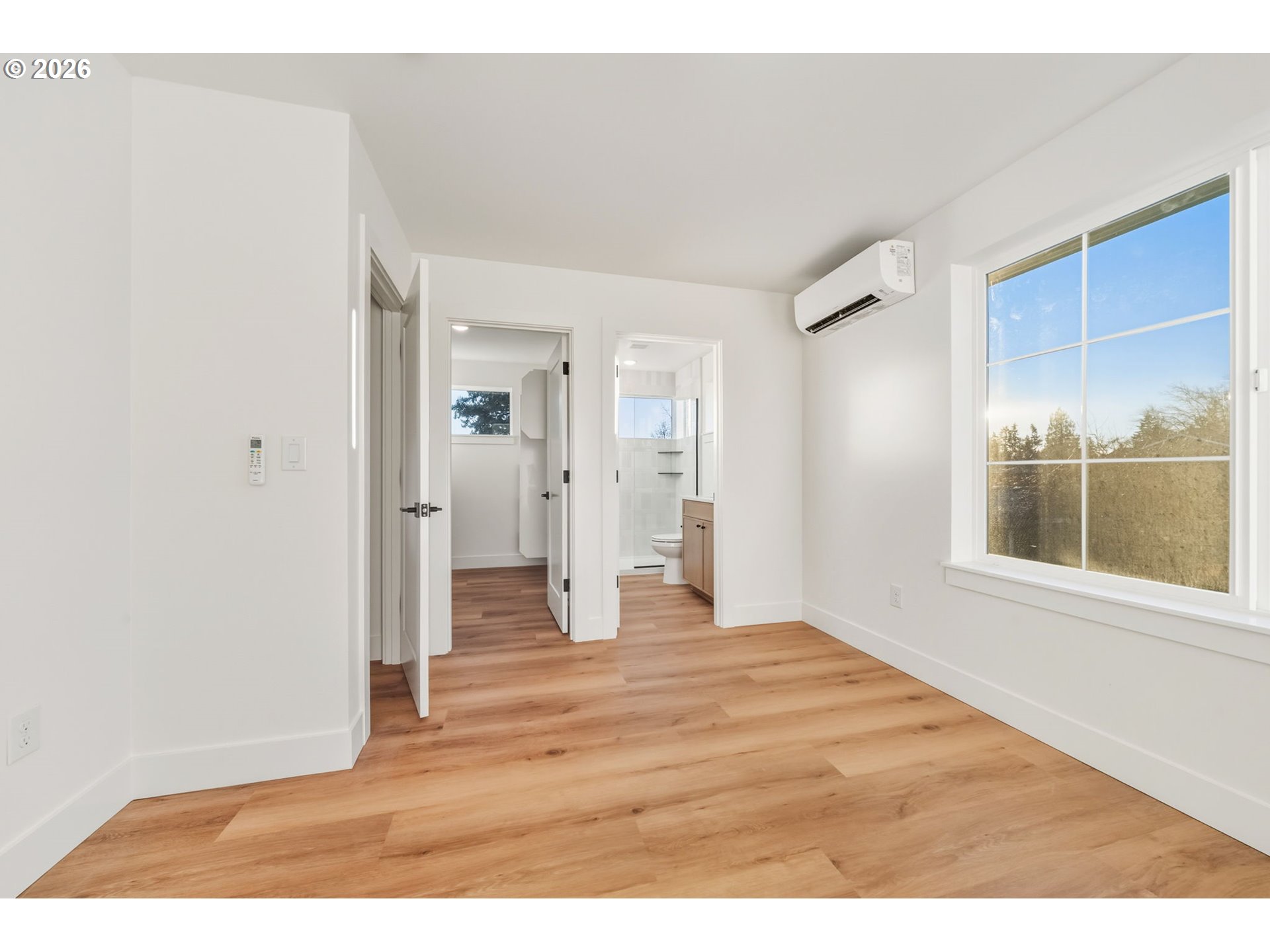 7332 Southeast Bybee Boulevard, Unit 2 Portland, OR 97206 - Photo 12 of 19 a view of an empty room with wooden floor and a window