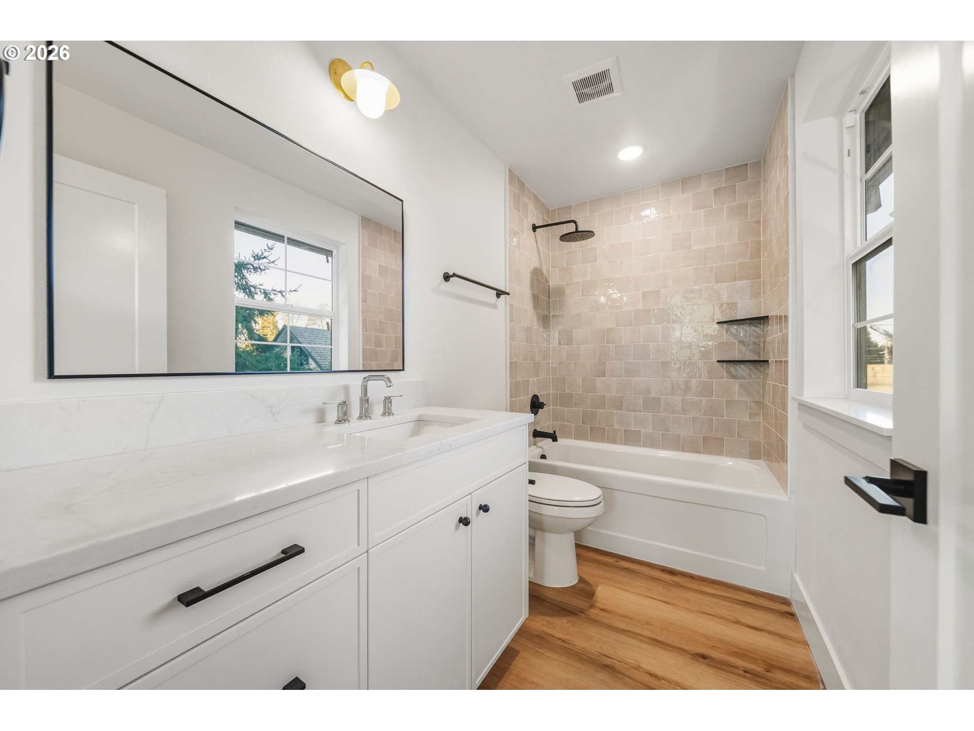 7332 Southeast Bybee Boulevard, Unit 2 Portland, OR 97206 - Photo 15 of 19 a bathroom with a sink a toilet and a bathtub