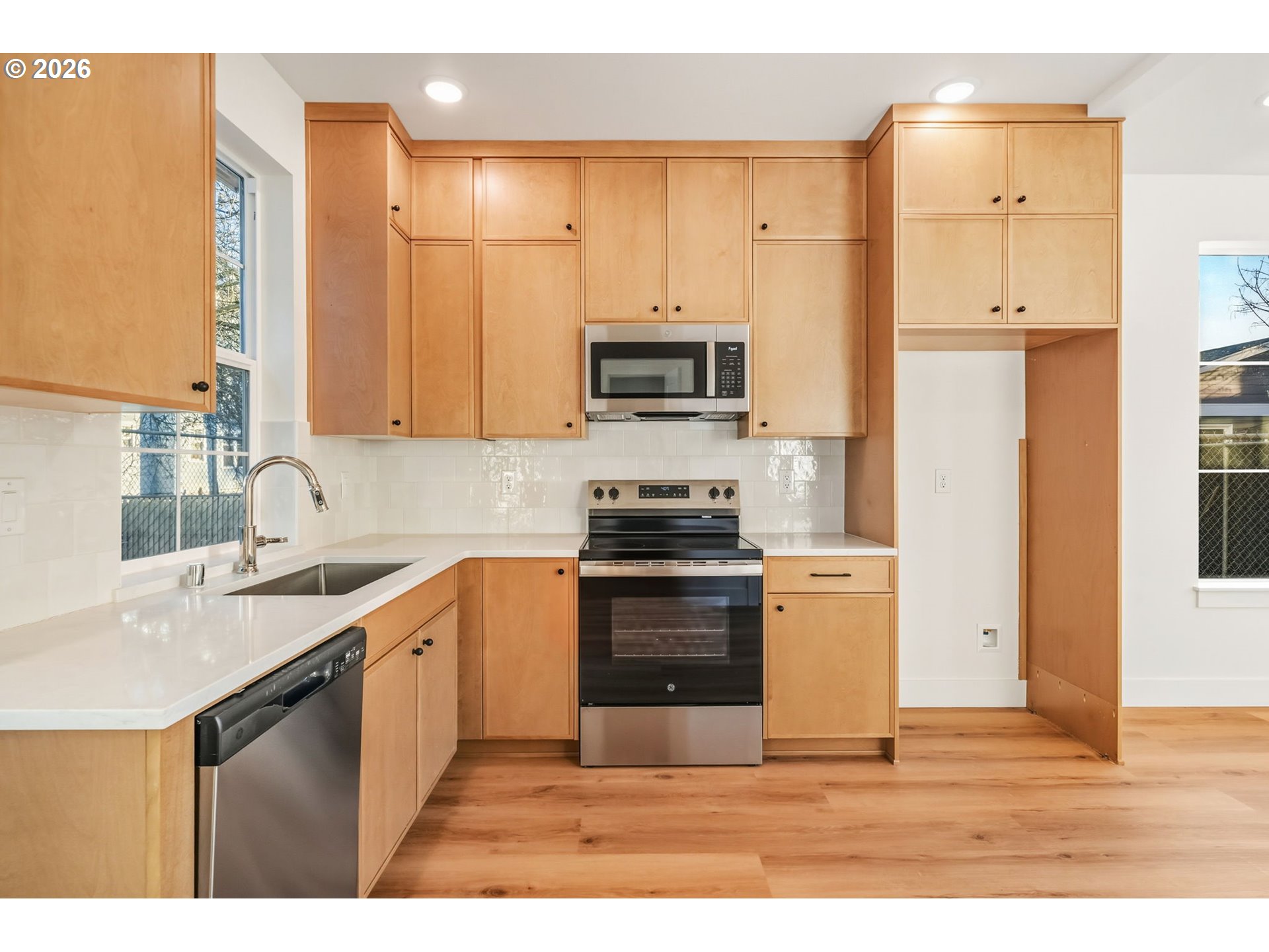 7332 Southeast Bybee Boulevard, Unit 2 Portland, OR 97206 - Photo 6 of 19 a kitchen with stainless steel appliances granite countertop a stove a sink and a refrigerator