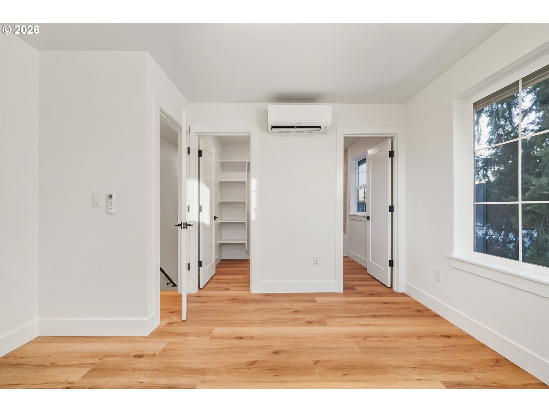 7332 Southeast Bybee Boulevard, Unit 2 Portland, OR 97206 - Photo 10 of 19 a view of empty room with wooden floor and window