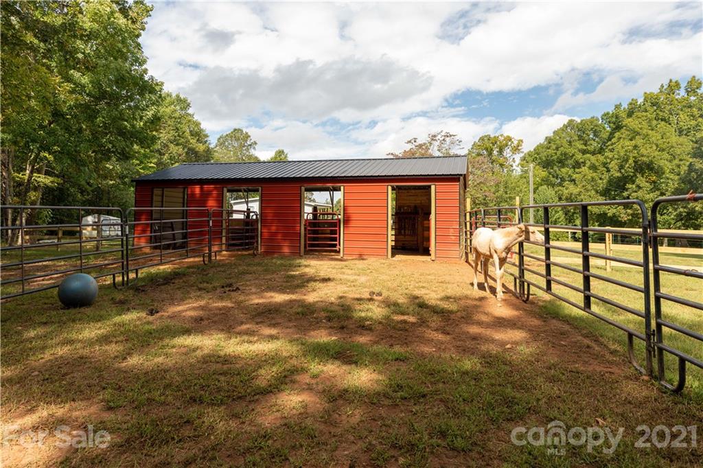 1824 Ebenezer Road Smyrna, SC 29743 - Photo 7 of 47 a view of a backyard with floor to ceiling window and tree