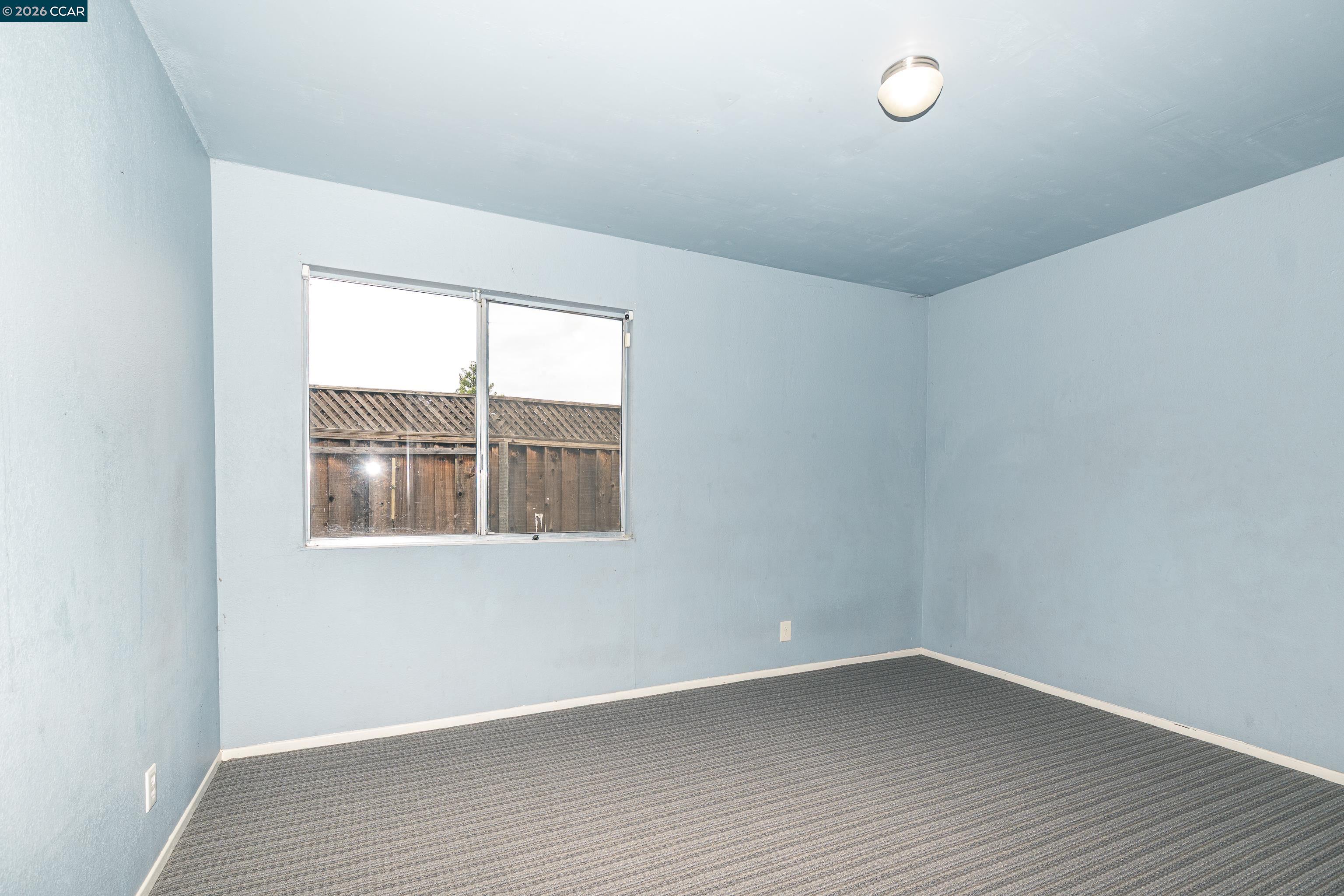 1730 Springwood Way Antioch, CA 94509 - Photo 15 of 26 an empty room with wooden floor and windows