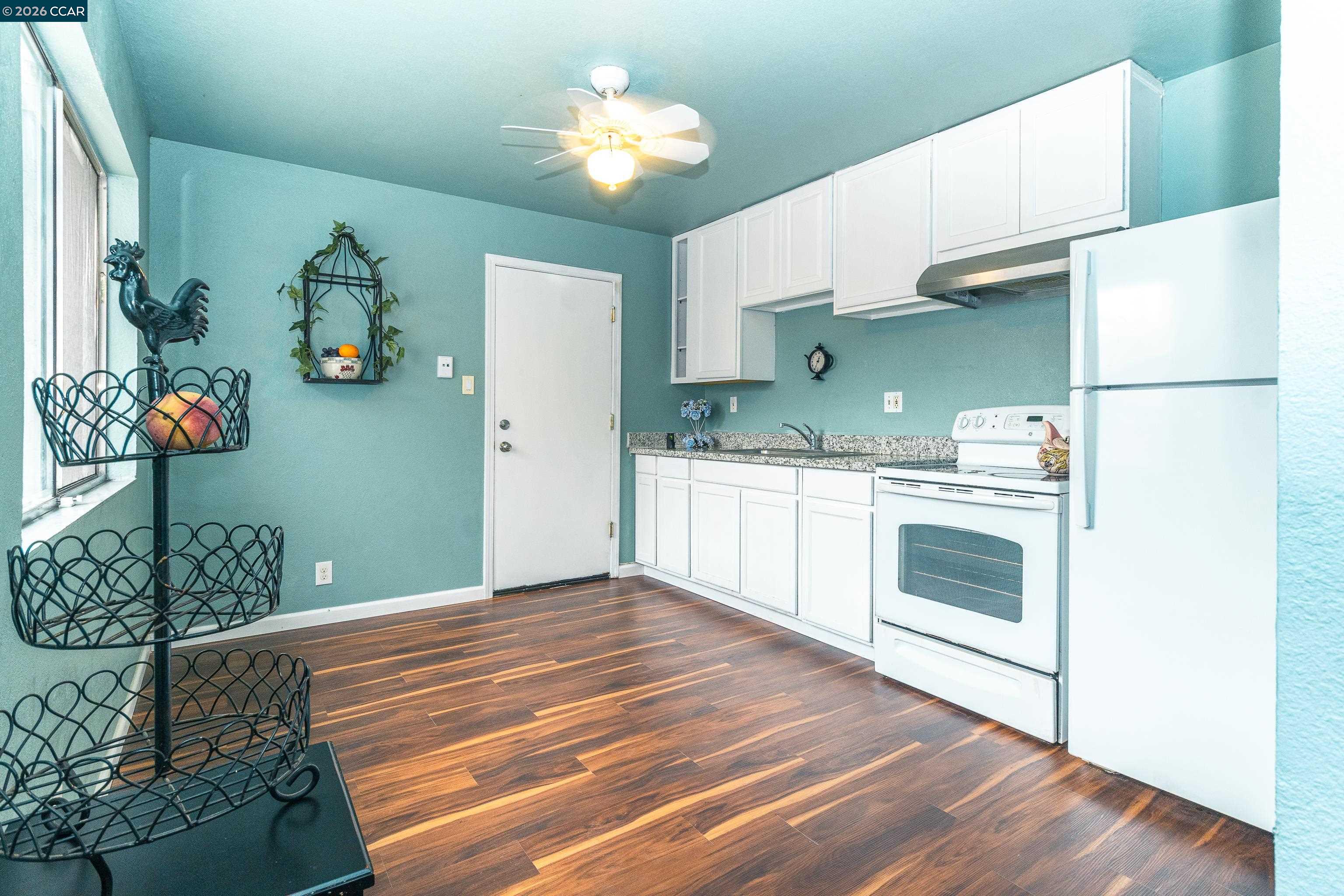 1730 Springwood Way Antioch, CA 94509 - Photo 10 of 26 a kitchen with cabinets and wooden floor