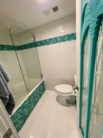 en suite bathroom with granite countertop sink and a mirror