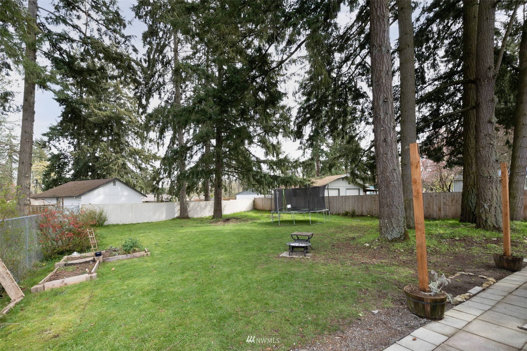 8301 Custer Road Southwest Lakewood, WA 98499 - Photo 28 of 34 a front view of a house with garden and trees