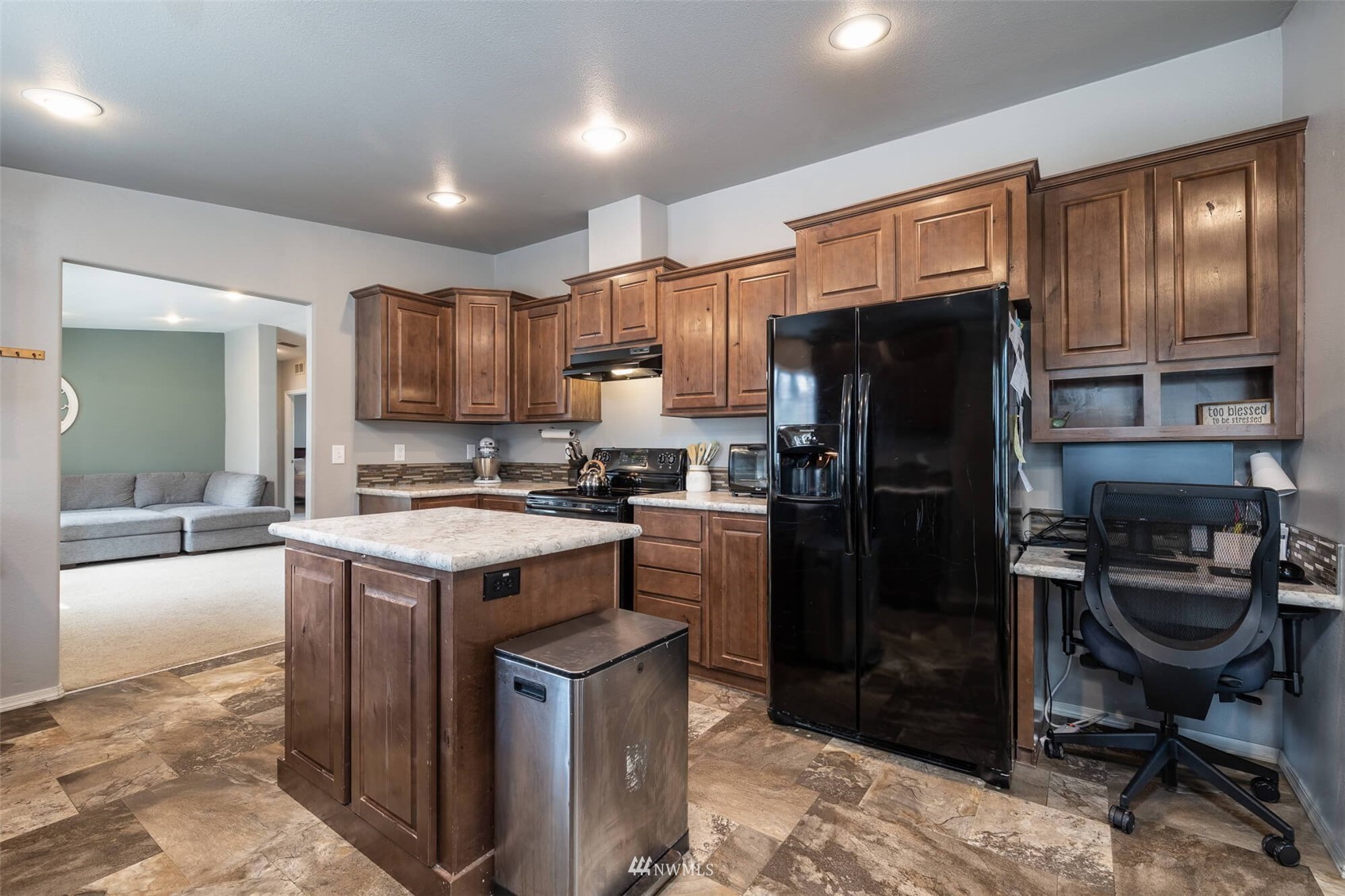 8301 Custer Road Southwest Lakewood, WA 98499 - Photo 8 of 34 a kitchen with a refrigerator a sink and wooden cabinets