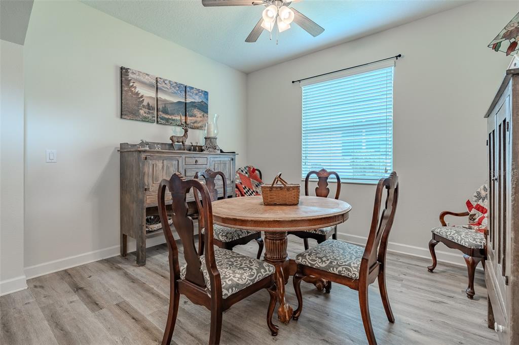 9224 Southwest 60th Ct Road Ocala, FL 34476 - Photo 25 of 55 a view of a dining room with furniture and wooden floor