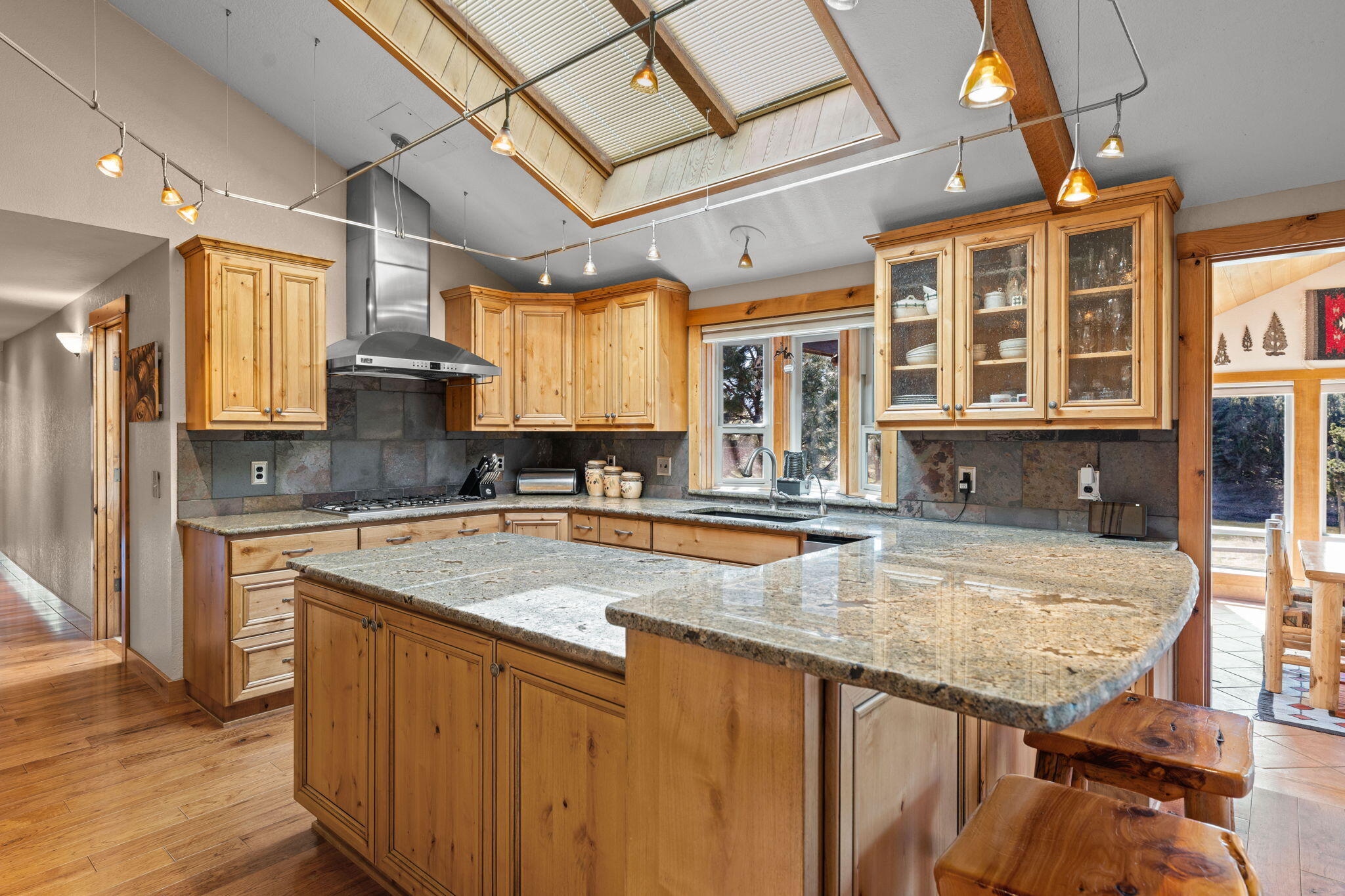 17375 Jordan Road Sisters, OR 97759 - Photo 18 of 63 Beautiful kitchen with large island, granite countertops, breakfast bar, and GE Monogram range, hood, and oven.