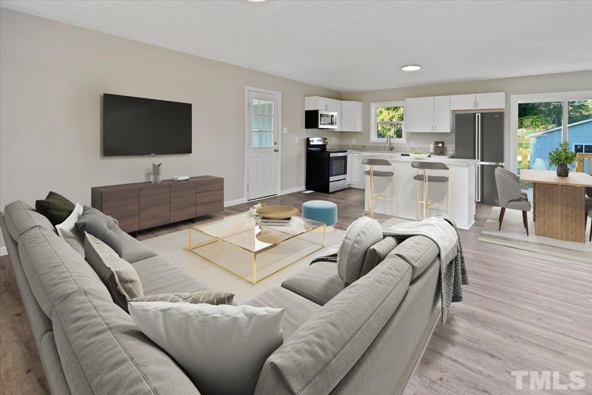 633 Outlaw Road Dudley, NC 28333 - Photo 11 of 28 a living room with furniture and a flat screen tv