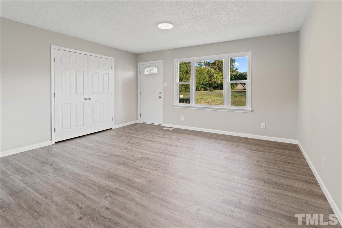 633 Outlaw Road Dudley, NC 28333 - Photo 14 of 28 a view of an empty room with wooden floor and a window