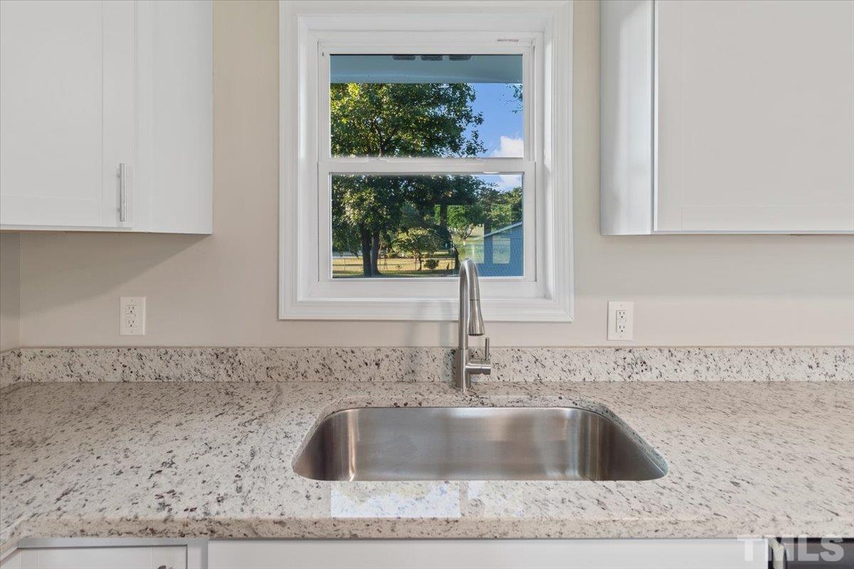 633 Outlaw Road Dudley, NC 28333 - Photo 17 of 28 a kitchen with granite countertop a sink and a window