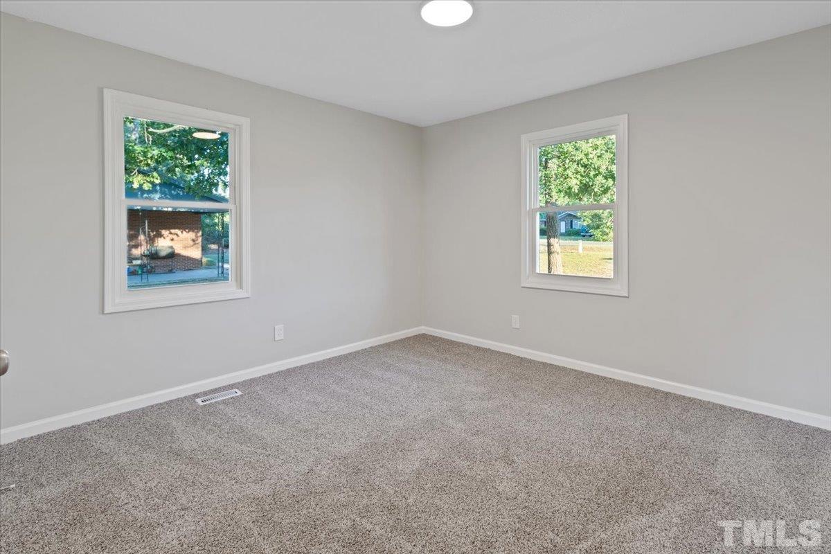 633 Outlaw Road Dudley, NC 28333 - Photo 25 of 28 an empty room with windows