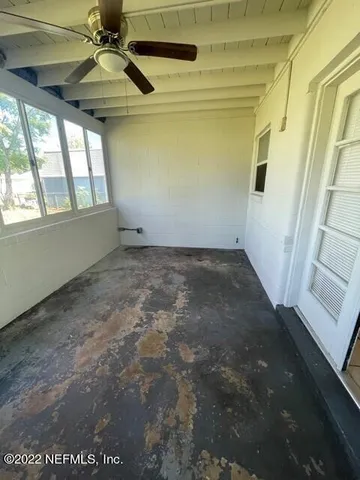 a view of an empty room with a window