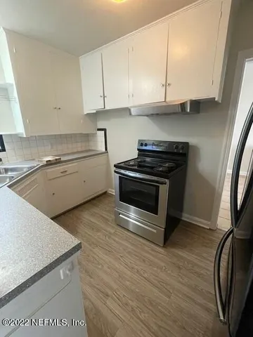 a kitchen with a stove and a sink