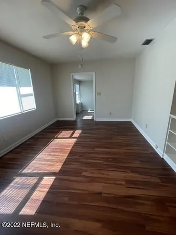 a view of a livingroom with a ceiling fan and wooden floor