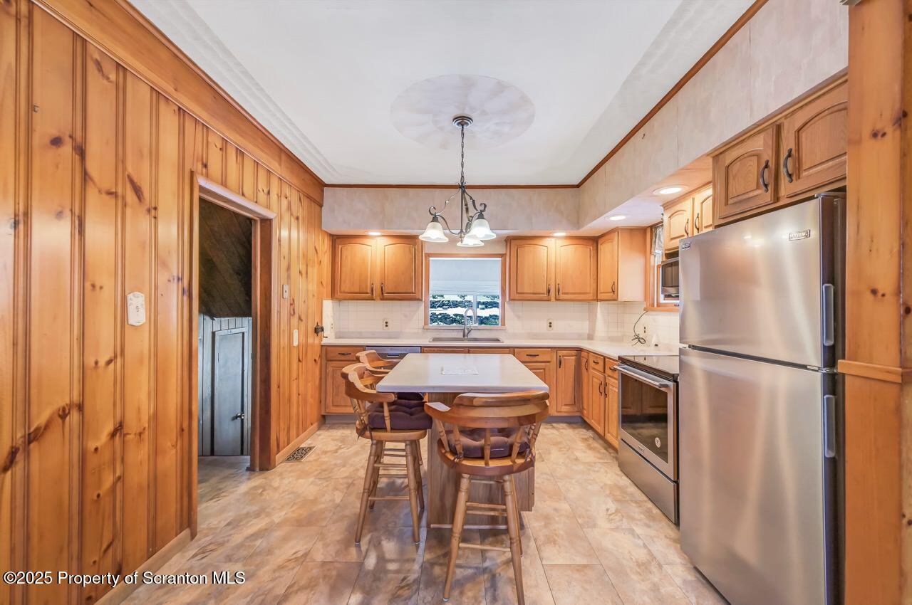 9 Marcy Road Tunkhannock, PA 18657 - Photo 14 of 97 a kitchen with a refrigerator a dining table and chairs