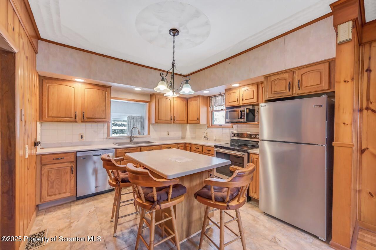 9 Marcy Road Tunkhannock, PA 18657 - Photo 15 of 97 a kitchen with stainless steel appliances a dining table chairs refrigerator and sink