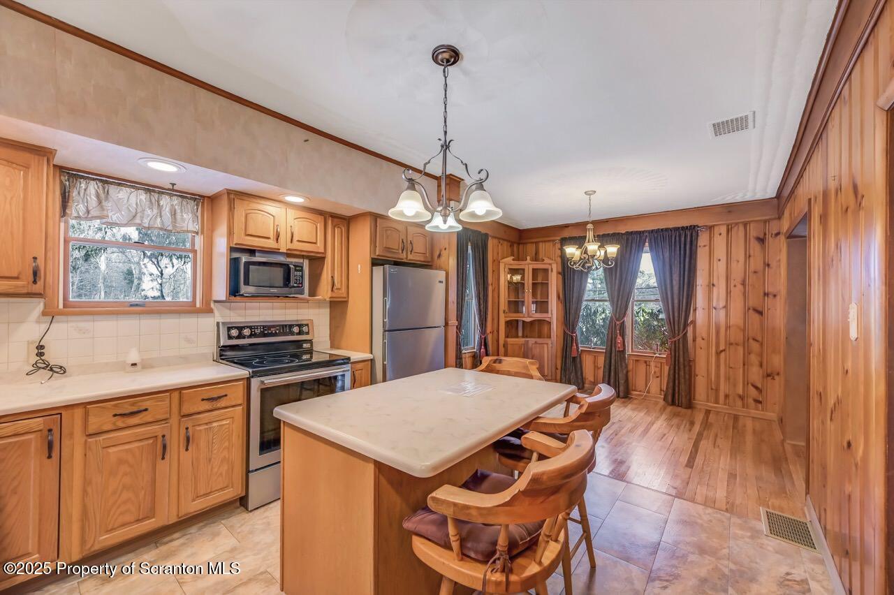 9 Marcy Road Tunkhannock, PA 18657 - Photo 17 of 97 a open kitchen with stainless steel appliances granite countertop a stove a sink dishwasher and a refrigerator with wooden cabinets