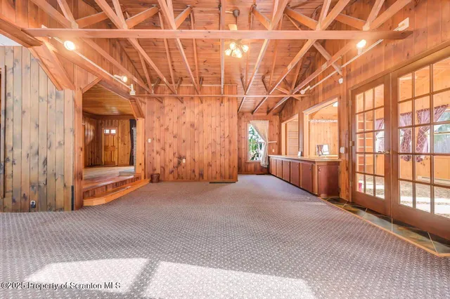 a bathroom with a granite countertop sink a mirror a vanity and shower
