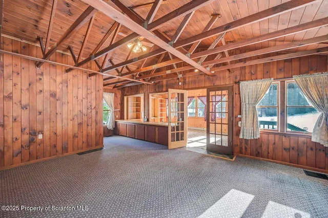 a kitchen that has a lot of cabinets in it and wooden floor