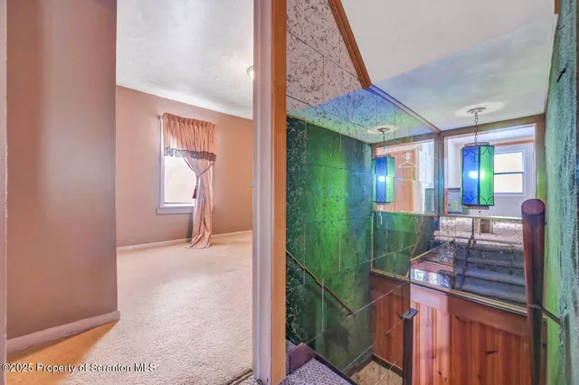 a view of a house with snow on the side of the road