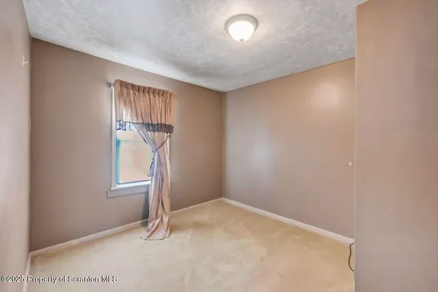 a view of a house with snow on the background
