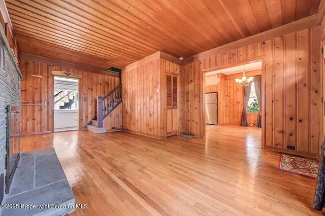 a kitchen with a refrigerator a dining table and chairs