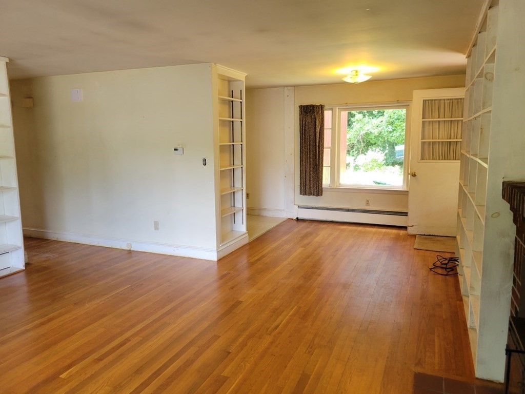 38 Bigelow Road Lancaster, MA 01523 - Photo 11 of 26 an empty room with wooden floor and windows