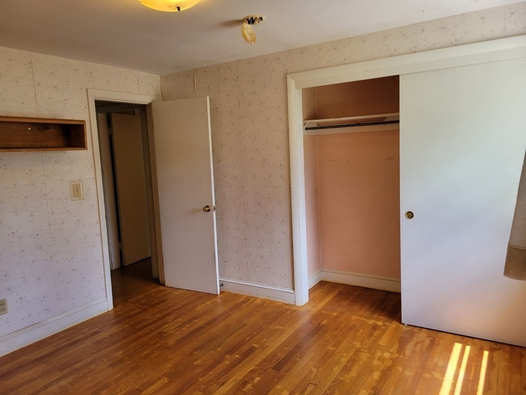 38 Bigelow Road Lancaster, MA 01523 - Photo 14 of 26 a view of an empty room with wooden floor and closet