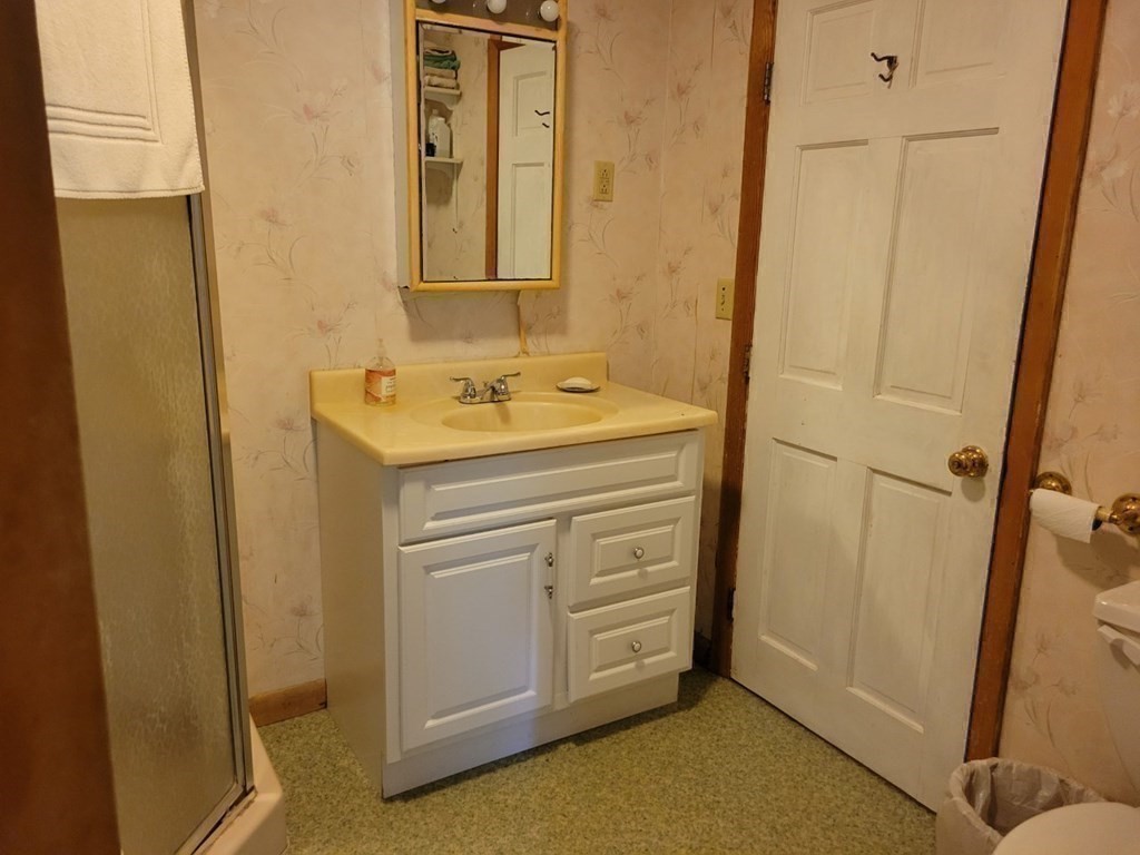 38 Bigelow Road Lancaster, MA 01523 - Photo 18 of 26 a bathroom with a sink and a mirror