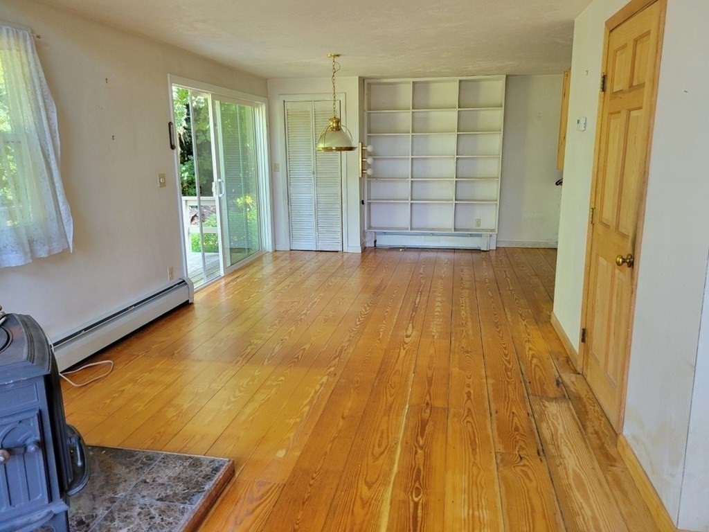 38 Bigelow Road Lancaster, MA 01523 - Photo 5 of 26 a view of an empty room with wooden floor and a window