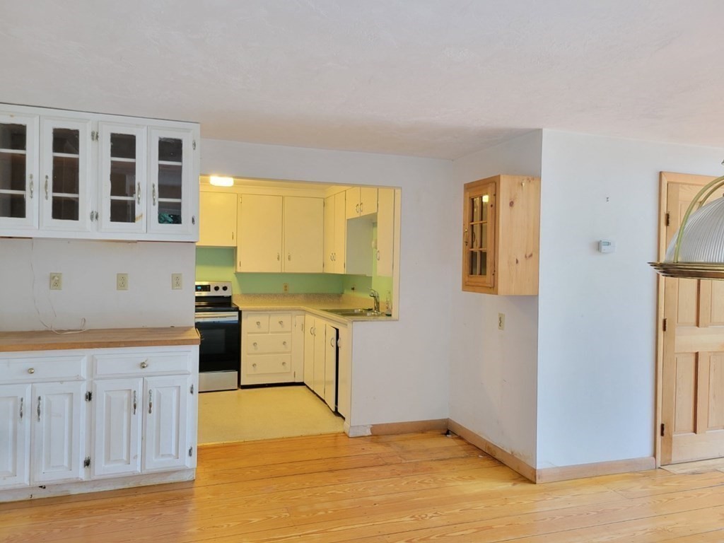38 Bigelow Road Lancaster, MA 01523 - Photo 6 of 26 a kitchen with wooden cabinets and a sink