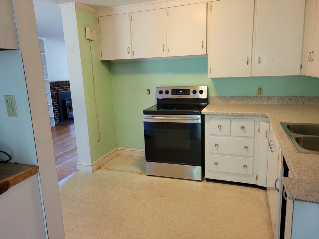 38 Bigelow Road Lancaster, MA 01523 - Photo 7 of 26 a kitchen with a stove and cabinets