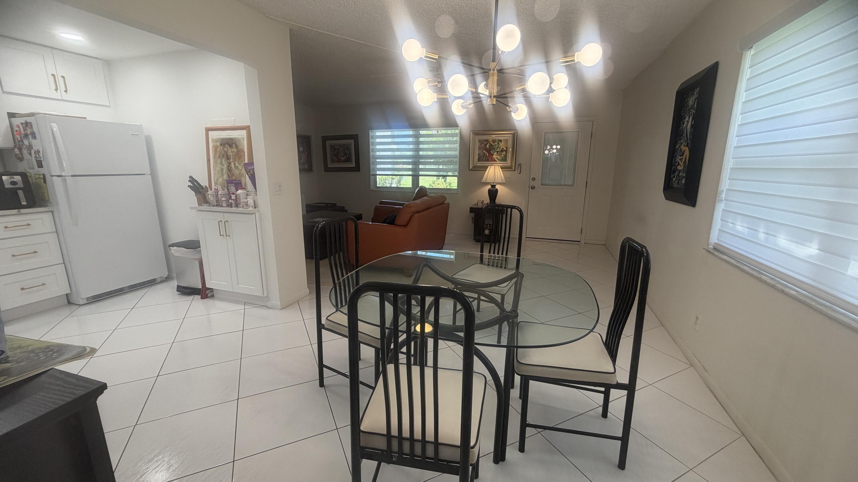 930 Normandy Trail Delray Beach, FL 33484 - Photo 13 of 34 a dining room with furniture and window