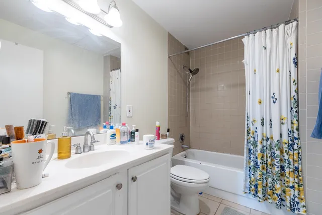 a bathroom with a sink a toilet and shower curtain