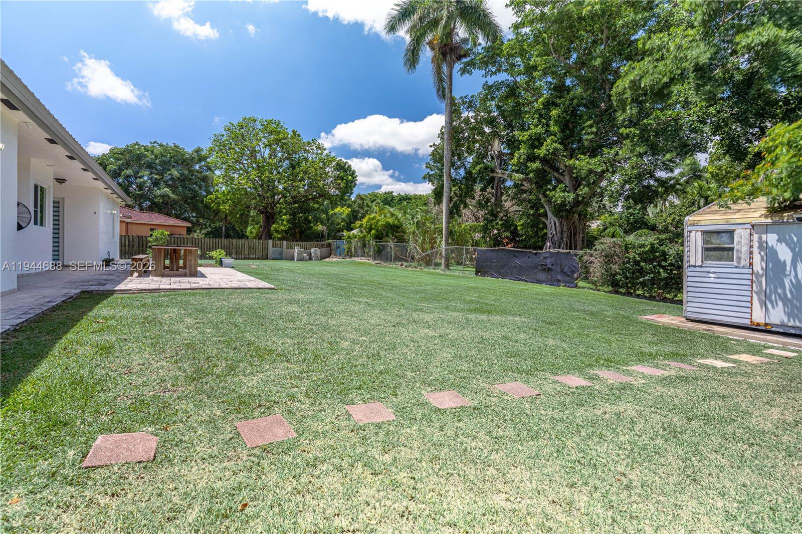 26602 Southwest 149th Court Homestead, FL 33032 - Photo 11 of 66 a backyard of a house with table and chairs