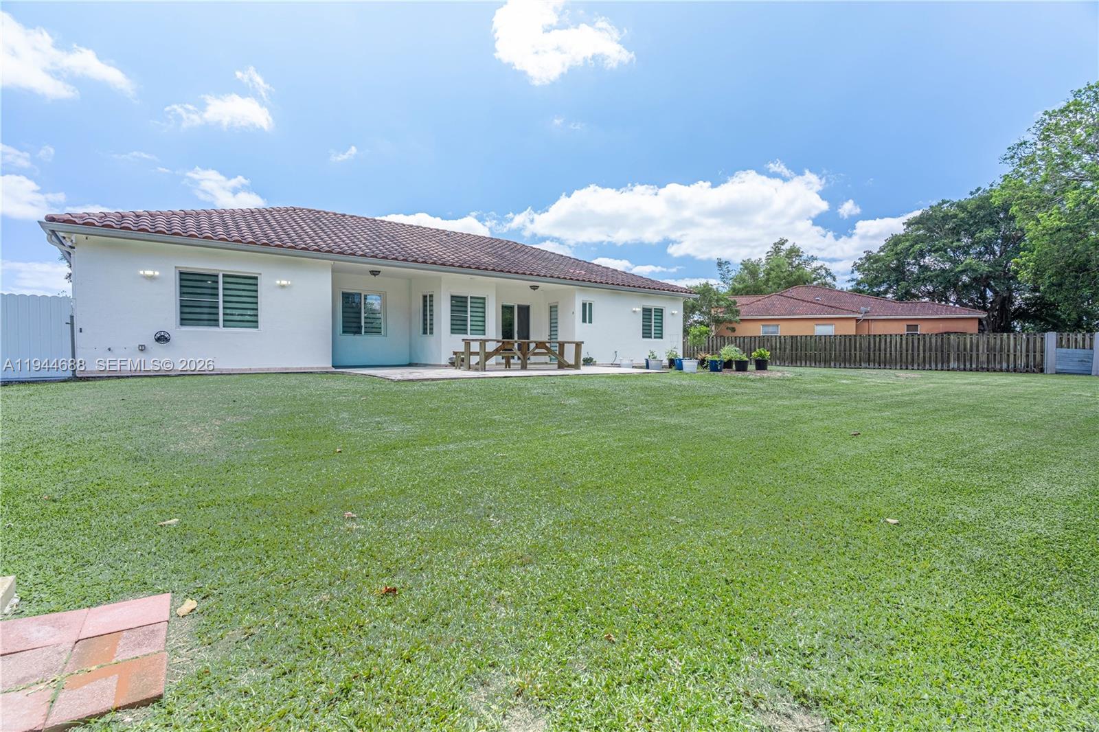26602 Southwest 149th Court Homestead, FL 33032 - Photo 13 of 66 a house view with a sitting space and garden