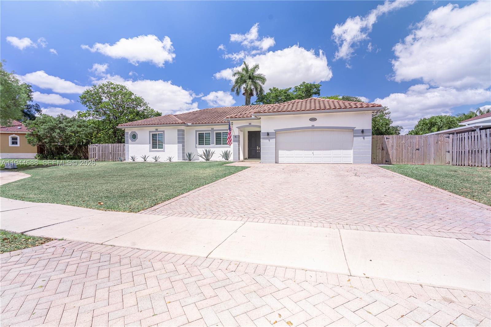 26602 Southwest 149th Court Homestead, FL 33032 - Photo 2 of 66 a view of a house with a yard and potted plants
