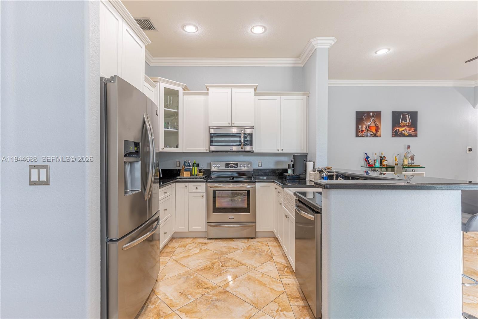 26602 Southwest 149th Court Homestead, FL 33032 - Photo 30 of 66 a kitchen with stainless steel appliances granite countertop a refrigerator and a stove top oven