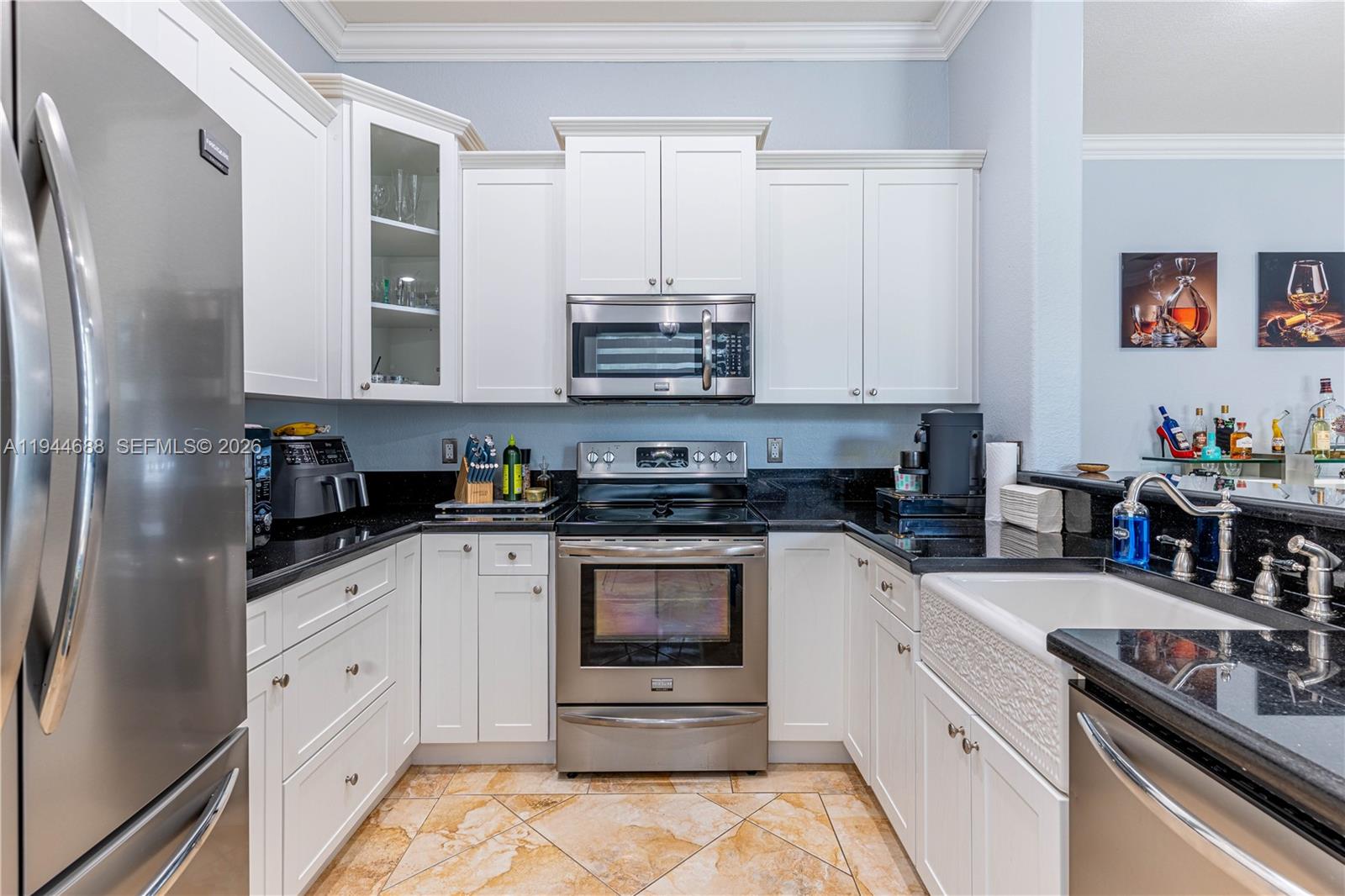 26602 Southwest 149th Court Homestead, FL 33032 - Photo 31 of 66 a kitchen with stainless steel appliances granite countertop a stove a sink and a refrigerator