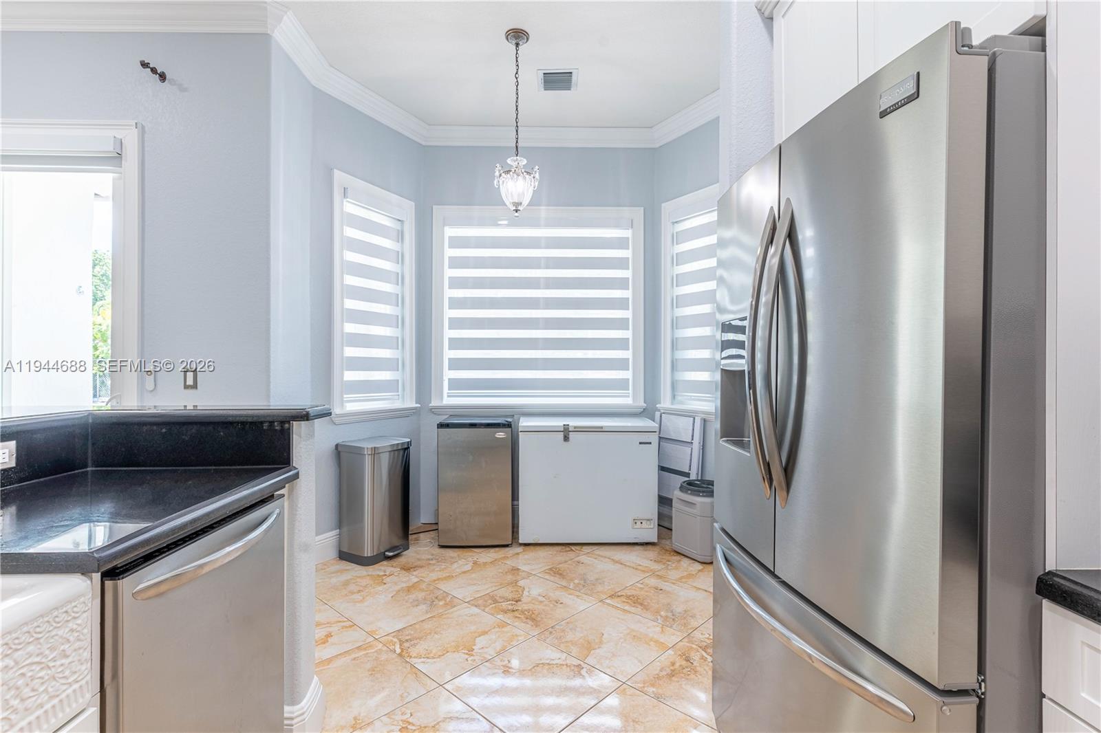 26602 Southwest 149th Court Homestead, FL 33032 - Photo 32 of 66 a kitchen with stainless steel appliances granite countertop a refrigerator and a sink