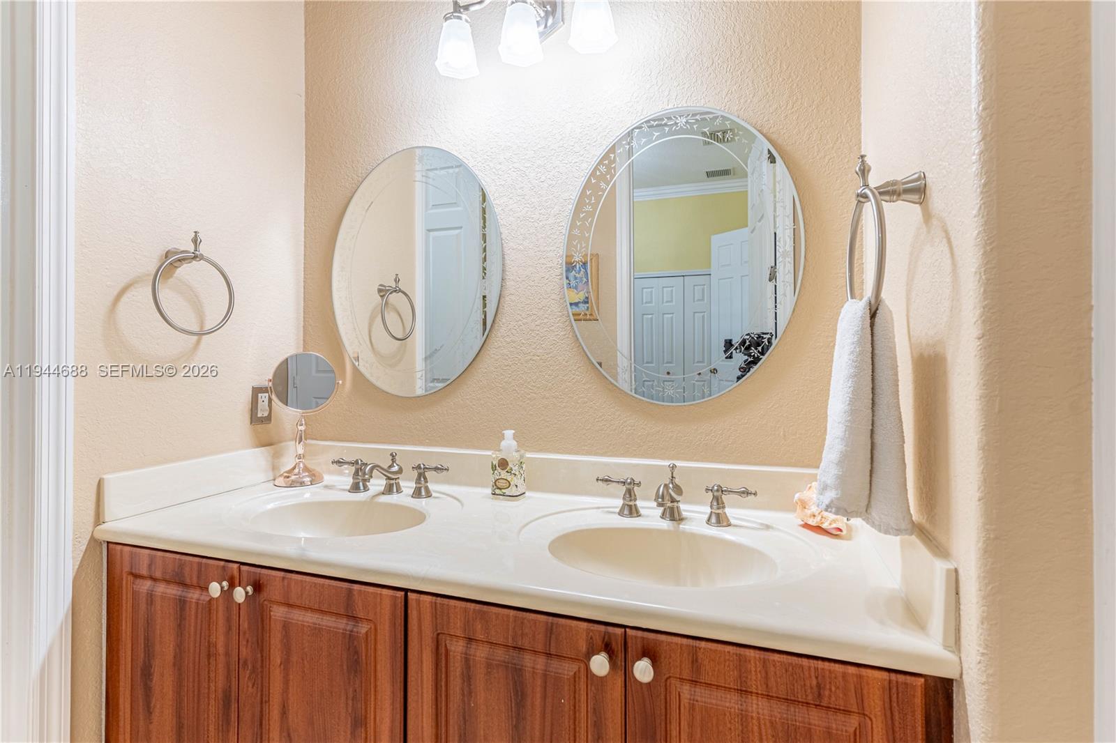 26602 Southwest 149th Court Homestead, FL 33032 - Photo 37 of 66 a bathroom with a double vanity sink and a mirror