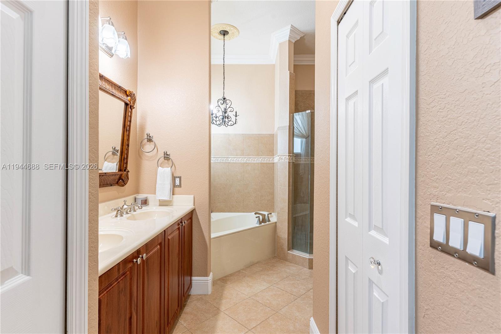 26602 Southwest 149th Court Homestead, FL 33032 - Photo 50 of 66 a bathroom with a double vanity sink and a bathtub