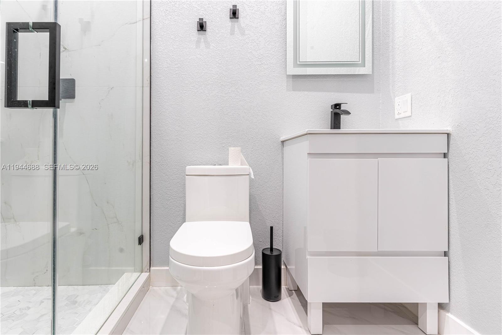 26602 Southwest 149th Court Homestead, FL 33032 - Photo 64 of 66 a white toilet sitting next to a bathroom sink