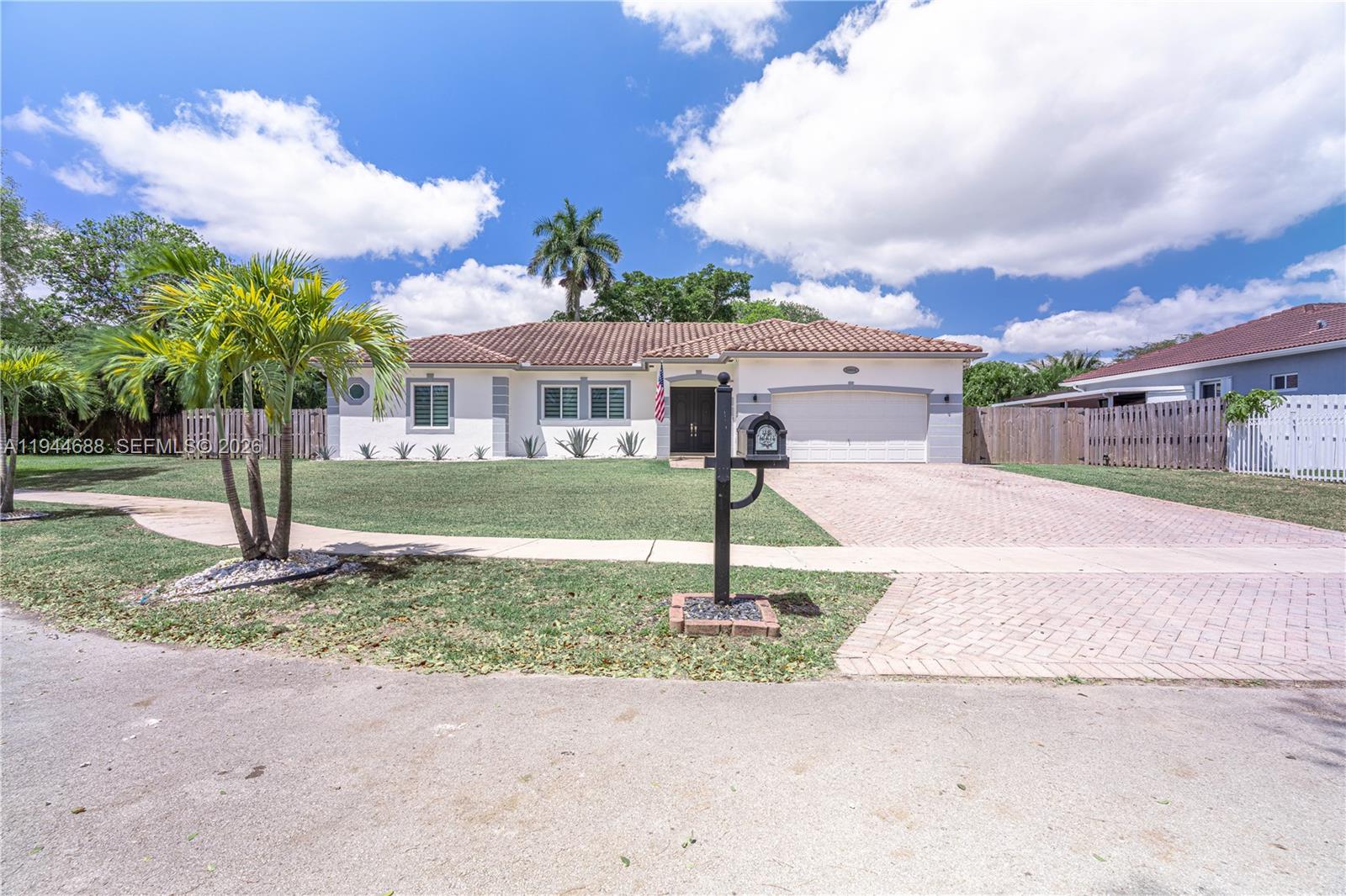 26602 Southwest 149th Court Homestead, FL 33032 - Photo 8 of 66 a front view of a house with a yard and palm trees