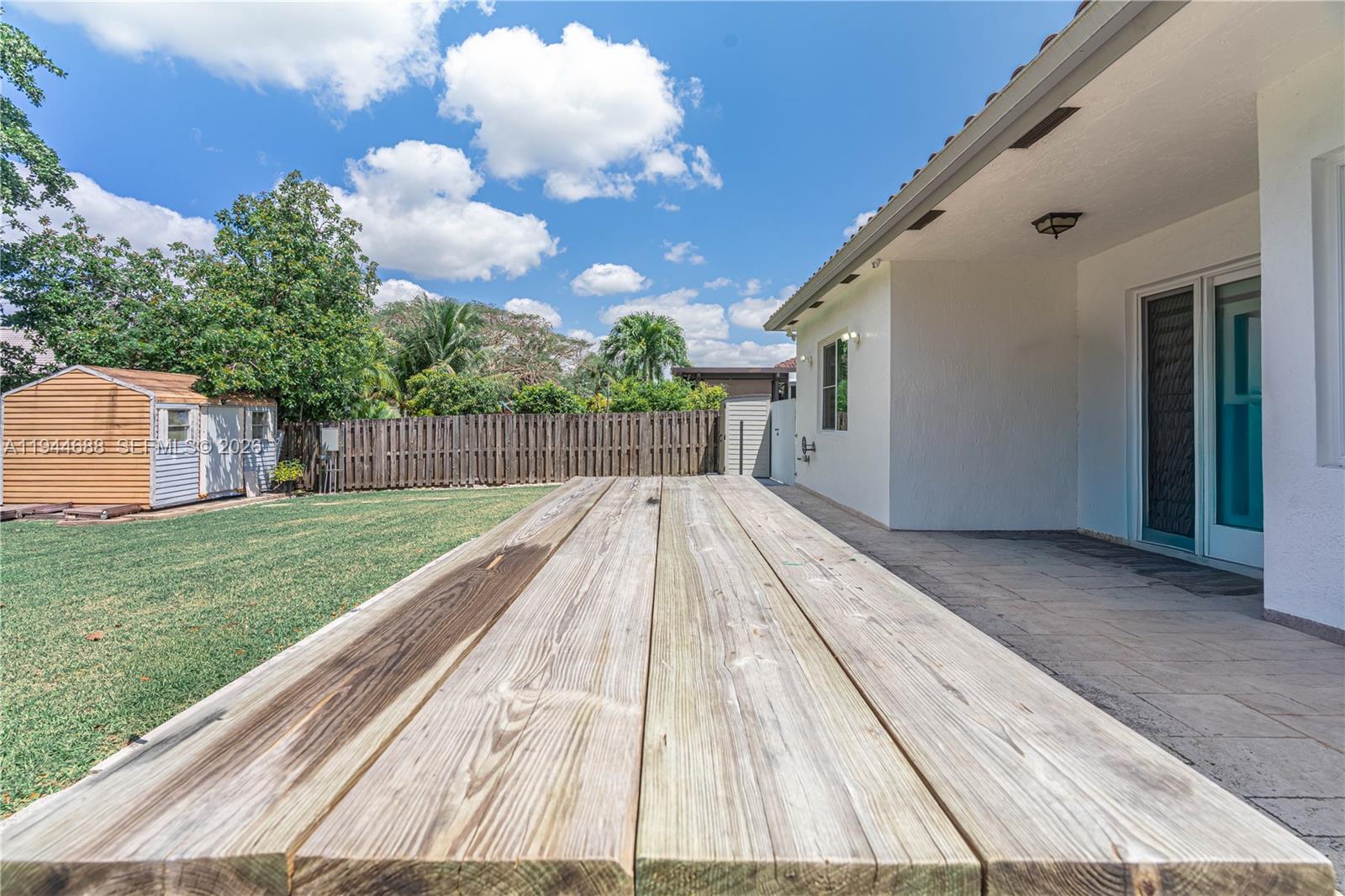 26602 Southwest 149th Court Homestead, FL 33032 - Photo 10 of 66 a view of backyard with wooden floor and fence